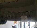 a picture of a kitchen with a lot of glasses hanging from the ceiling