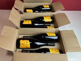 six bouteilles de vin sont posées sur une table dans un carton