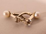 a close up of a ring with pearls on it