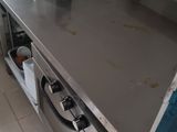 a stainless steel counter in a kitchen with a blue door