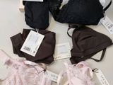 several bras and underwear are on a table with tags on them
