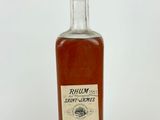 a close up of a bottle of rum on a white surface