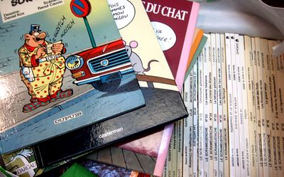 a pile of children ' s books sitting on a table