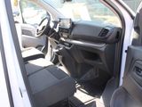 the interior of a white van with the driver ' s seat up
