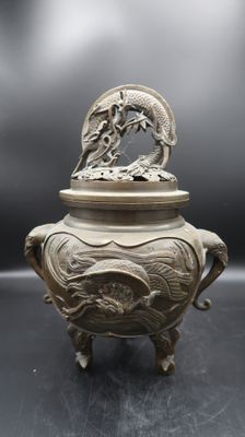 an antique chinese silverware with a dragon on top