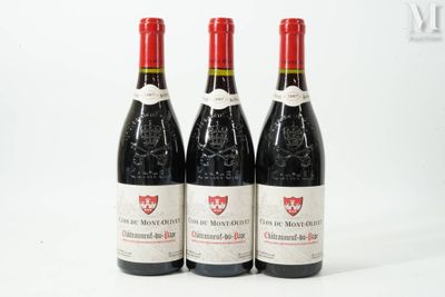 three bottles of red wine sitting next to each other on a white surface