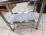 a stainless steel table with a metal shelf on it
