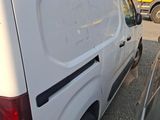 a white van parked in a parking lot with a bicycle on the back of the van