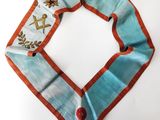 a blue and orange scarf with a bird design on it
