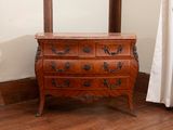 a dresser with a mirror on top of it in the corner of a room