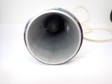 a black and white photo of a speaker on a table