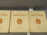 three books on display in a case on a shelf in a room