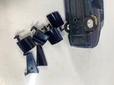 a small blue toy car and a couple of other toy cars on a white surface
