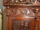 a wooden cabinet with carvings on it in a room