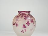 a glass vase with a pink flower design on it