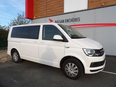 the white van is parked in front of a building