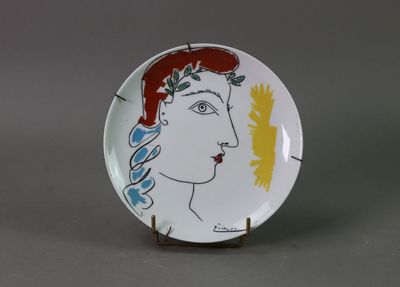 an image of a plate with a woman ' s face painted on it