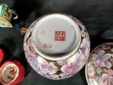 a vase with a lid sitting on a table next to other items