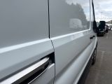 a silver van parked in a parking lot next to other cars