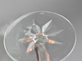 a glass with a flower inside of it on a table