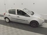a picture of a small white car parked in a garage