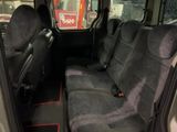 two seats in the back of a van that is parked