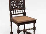 an old wooden chair with wicker seat on a white background