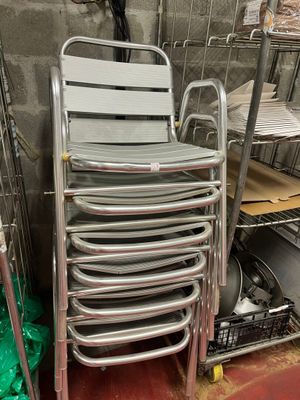 a lot of chairs that are stacked up in a room