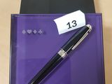a close up of a pen in a purple box with a price tag