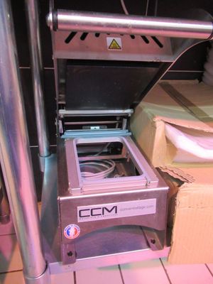 a machine that is sitting on the floor next to a box
