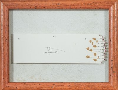 une photo encadrée représentant un bout de papier sur lequel figurent des inscriptions