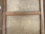 an old picture of a window with a wooden frame on it