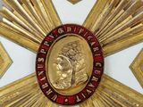 a close up of a medal with a gold star on it