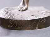 a bronze statue of a dog on a pedestal