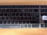 a computer keyboard on a table with a price tag on it