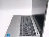 a silver laptop computer sitting on a white surface
