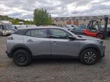 nissan c - hr suv in a parking lot with a forklift truck in the background