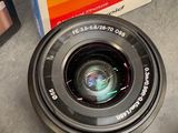 a camera lens sitting on top of a table next to a cell phone