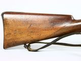 a close up of a rifle with a wooden barrel on a white background