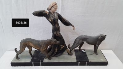 statue of a woman and two dogs on a marble base