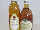 two bottles of alcohol sitting next to each other on a white surface