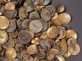 a pile of coins on a table with a black background