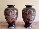 two vases that are sitting on a table