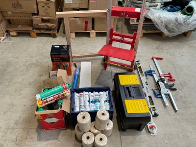 a pile of supplies sitting on the floor next to a chair