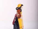 a small figurine of a woman in a yellow dress