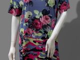 the mannequin is wearing a colorful dress with flowers on it