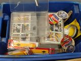 a blue container filled with assorted items on a table
