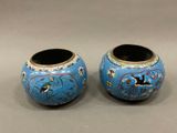pair of blue vases with birds and flowers painted on them