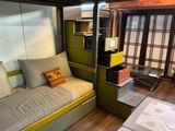 a bunk bed with a couch underneath it in a room