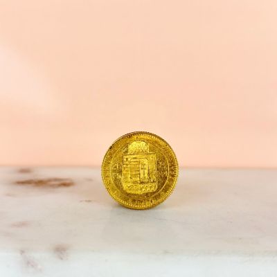 an image of a gold coin sitting on top of a marble counter